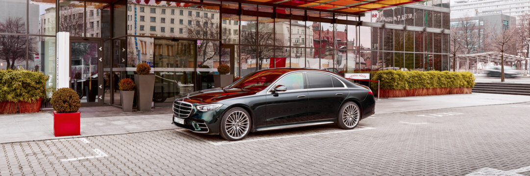 Luxurious Mercedes S Class, is parked in the driveway of the Vienna House Hotel. Black color, rear view. Katowice, Poland - 02.02.2021