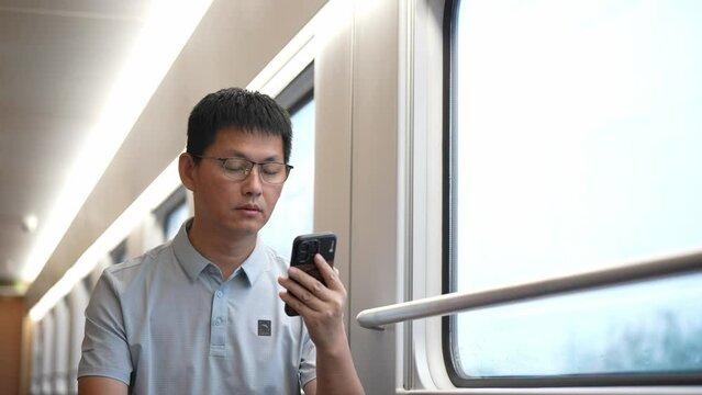 people using mobile phone on train