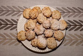 a plate of pine nut cookies on a table 