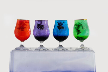 Four different colors in glasses in an aquarium