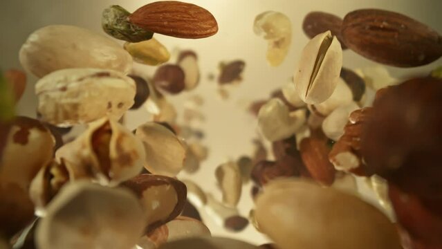 Super Slow Motion Closeup Shot of Falling and Rotating Various Nuts From Behind Camera at 1000fps.