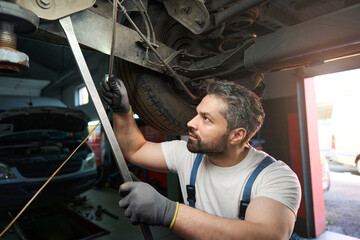 Fototapeta na wymiar Auto repair shop worker checking client motor vehicle