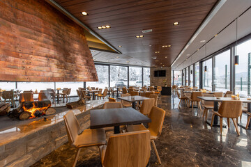 Interior of an empty modern mountain restaurant with marble floor