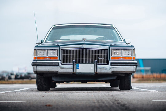 Brno, Czech republic - 31 December 2023: Old American classic car Cadillac Fleetwood from the 1980s outside in the parking lot. Look from front of lights, mask and bumper.