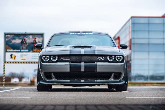 Brno, Czech republic - 31 December 2023: A gray Dodge Challenger is parked in the parking lot. Fast luxury sports car. American muscle car view of the front grille and lights.