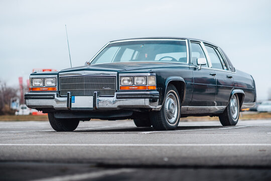 Brno, Czech republic - 31 December 2023: Old American classic car Cadillac Fleetwood from the 1980s outside in the parking lot. Look from front of lights, mask and bumper.