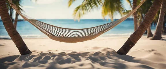 Fototapete Beachside Hammock Relaxation A relaxing scene of a hammock strung between two palm trees on © vanAmsen