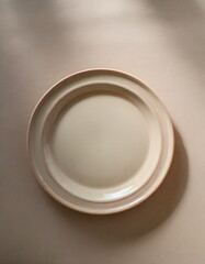 White ceramic plate mockup, blank template of dish on table