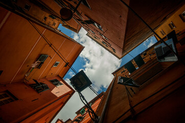 narrow, colorful streets, and courtyards, bottom view, geometry of facades, Liguria, Genoa, Italy