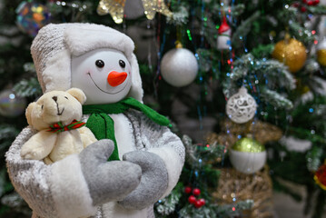 Presents and gifts with stuffed snowman under Christmas tree in living room. snowman under the tree Happy New Year.