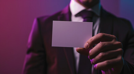 Young man holding a blank business card. Close-up shot.