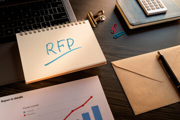 There is notebook with the word RFP. It is an abbreviation for Request For Proposal as eye-catching image.