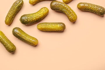 Pickled cucumbers on orange background