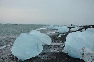 Crystal clear ice chunks on the black sand of Diamond beach in Fellsfjara, Jokulsarlon on Iceland