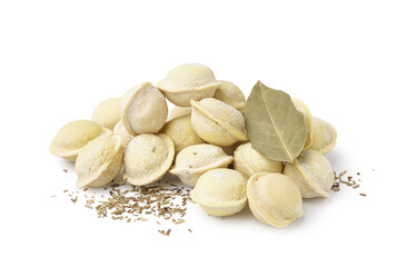 Raw dumplings with spices and bay leaf on white background