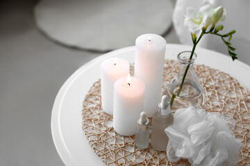 Spa composition with burning candles on table in salon, closeup