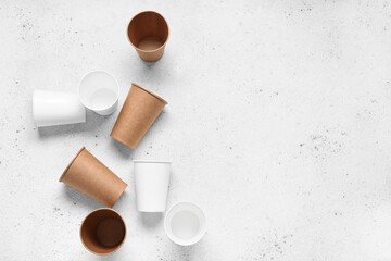 Different paper cups on white background