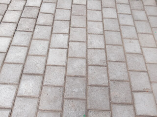 arrangement of paving blocks on the road. rectangular paving blocks. abstract background. texture