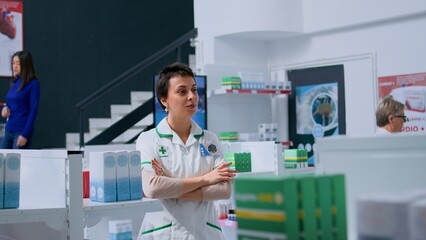 Portrait of friendly druggist in pharmacy waiting for customers to arrive, ready to provide pharmaceutical assistance. Happy healthcare expert in drugstore showing confidence and expertise