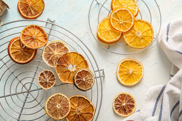 Stands with dried orange slices on light blue background