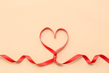 Heart made of red ribbon on color background. Valentine's Day celebration