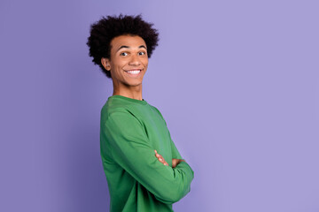 Photo of cool cheerful man dressed green sweater arms crossed empty space isolated violet color background