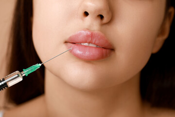 Young woman receiving lip injection, closeup