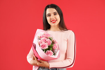 Beautiful young woman with bouquet of roses for Valentine's day on red background
