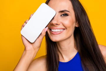 Photo of shiny cheerful woman wear blue top modern device close eye empty space isolated yellow color background