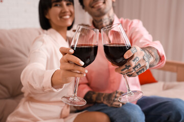 Young couple with glasses of wine at home. Valentine's day celebration