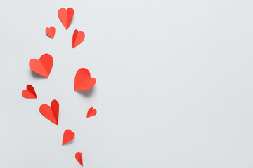 Composition with red paper hearts on grey background. Valentine's Day celebration