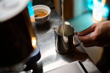 Barista making cappuccino pouring milk for prepare cup of coffee