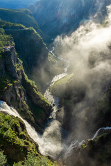 Beautiful view over the misty cliffs of the Voringfossen waterfall,  Norway