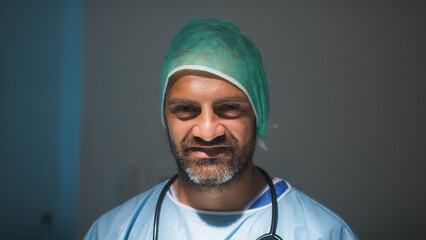 Italian man Doctor smile with lab coat and stethoscope in surgical room