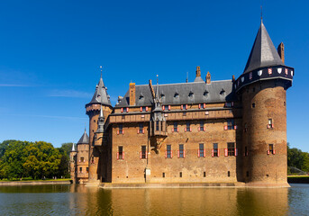 Fototapeta premium Picturesque summer landscape with a view of the ancient Castle De Haar, located near the city of Utrecht, Netherlands