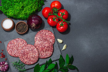 Raw burger patties. Fresh meat cutlets, spices, vegetables, herbs. Homemade American classic
