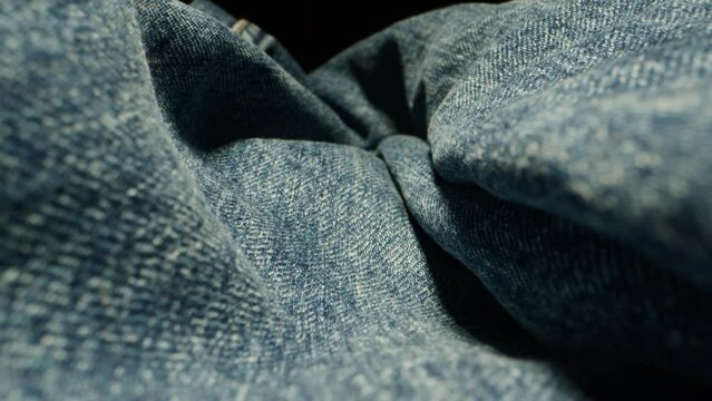 Blue textile jeans cloth texture close-up macro. Fashion fabric multicolor. Cotton. Clothes.