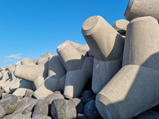 Blue sky and concrete breakwater.