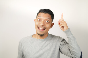 surprised, shocked expression of Asian Man with hand point, isolated background