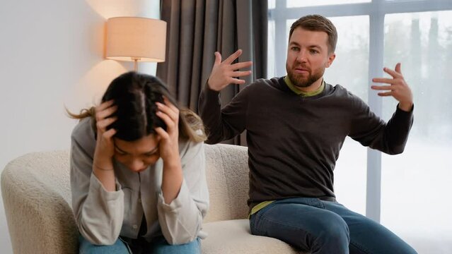 Couple quarrel. Sad hurt woman crying feel desperate jealous husband angry man shouting accusing talking to wife