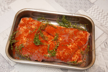 Pork belly steak seasoned with thyme, red onion, garlic and tomato sauce, stages of preparation