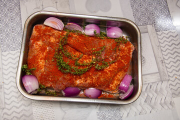 Pork belly steak seasoned with thyme, red onion, garlic and tomato sauce, stages of preparation