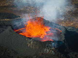 Awesome close up view of boiling red lava lake inside the active volcano crater, drone top down...