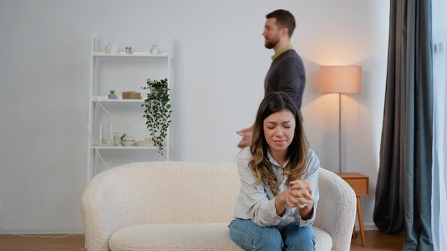 Domestic violence and abuse concept. Abusive husband arguing wife, jealous distrustful dominant man shouting at sad woman
