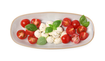 Plate of delicious Caprese salad with tomatoes, mozzarella, basil and spices isolated on white, top view