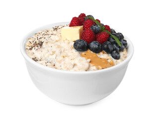 Tasty boiled oatmeal with berries, chia seeds and peanut butter in bowl isolated on white