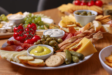 Assorted appetizers served on wooden table, closeup
