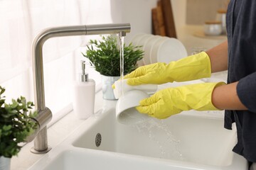 Woman washing cup at sink in kitchen, closeup - obrazy, fototapety, plakaty