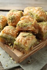 Delicious fresh baklava with chopped nuts on table, closeup. Eastern sweets