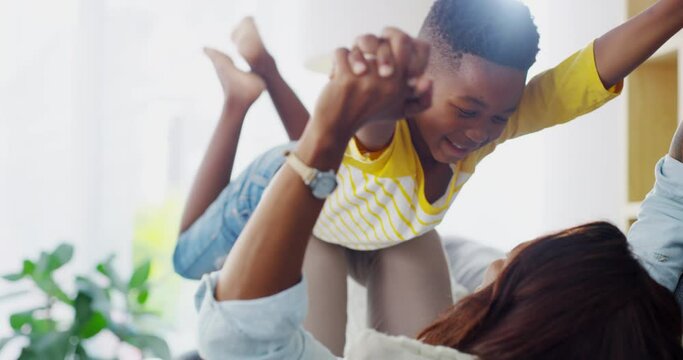 Airplane, love and mother with boy child on a sofa with care, fun and support at home together. Happy, black family and mom with kid in a house for flying, lifting or holding hands for weekend games